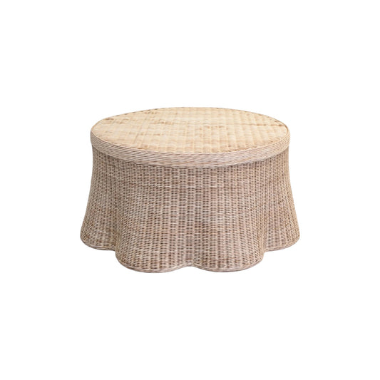 Wicker ottoman with a beige cushion on a white background